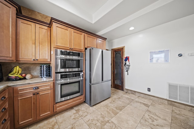 kitchen featuring appliances with stainless steel finishes and tasteful backsplash