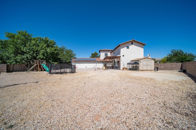 view of yard with a playground and a storage shed