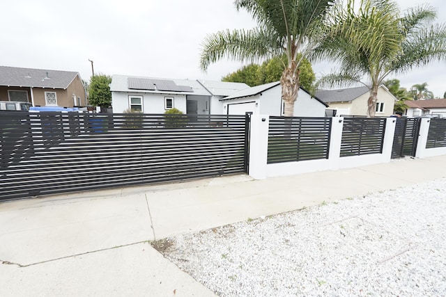 view of gate with a fenced front yard