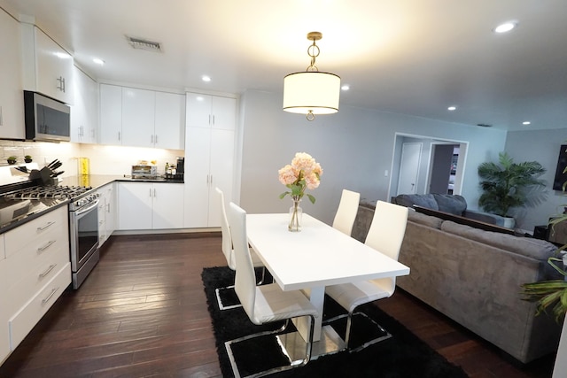 kitchen with dark wood-style floors, visible vents, recessed lighting, stainless steel appliances, and dark countertops