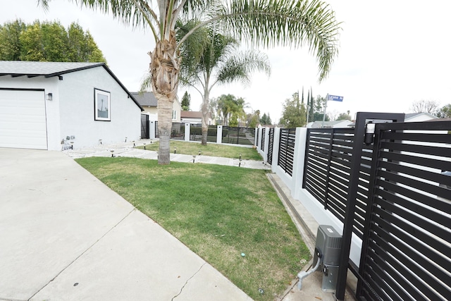 view of yard featuring a garage and fence private yard