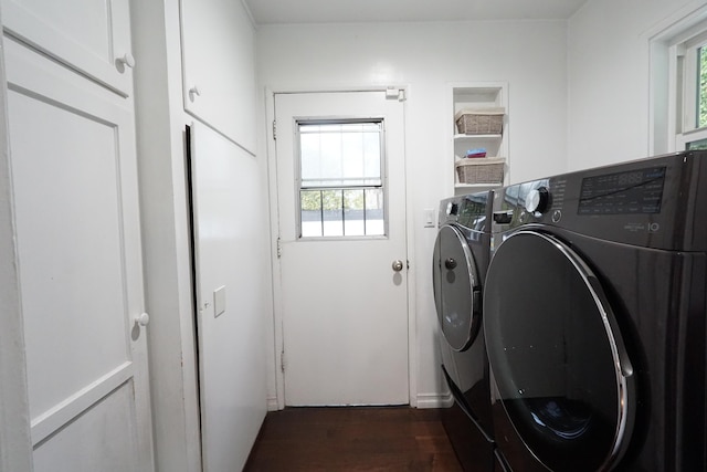 washroom featuring dark wood-style floors, cabinet space, separate washer and dryer, and a wealth of natural light