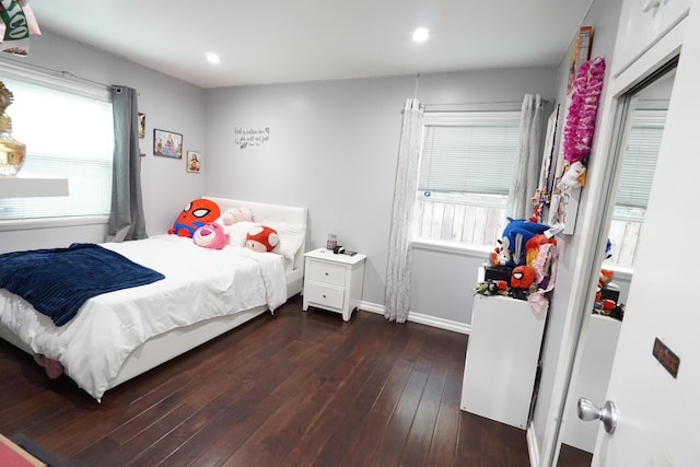 bedroom with multiple windows, baseboards, dark wood finished floors, and recessed lighting