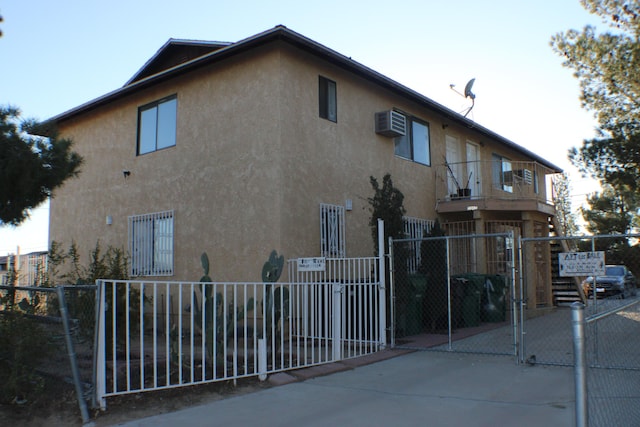 view of side of home featuring a wall mounted AC