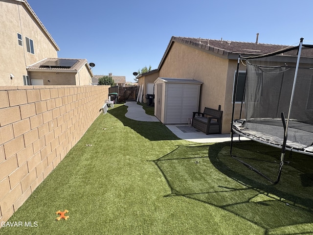 3309 W Brabham Ave, Rosamond, CA 93560 - fenced backyard with a trampoline, a shed, and a patio