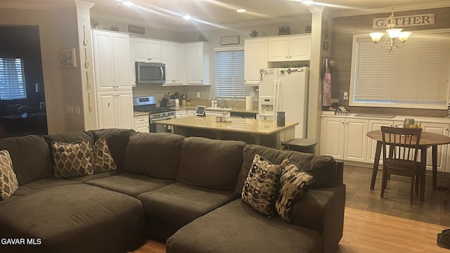 3309 W Brabham Ave, Rosamond, CA 93560 - living area with a chandelier, ornamental molding, and recessed lighting
