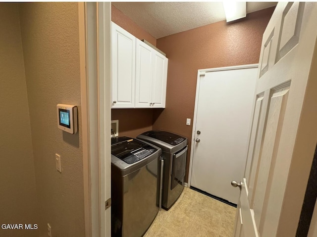 3309 W Brabham Ave, Rosamond, CA 93560 - laundry area with cabinet space, washer and dryer, a textured wall, and a textured ceiling