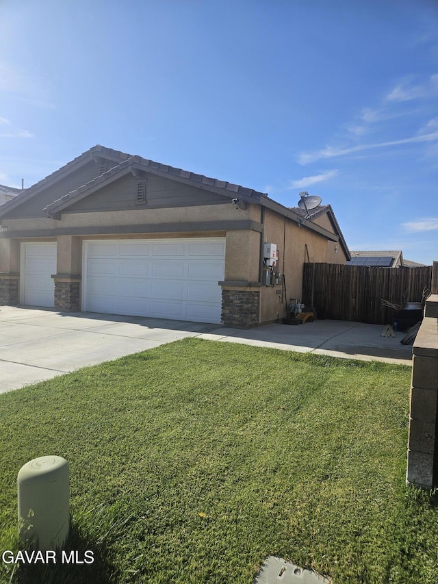 3309 W Brabham Ave, Rosamond, CA 93560 - view of front of property with driveway, an attached garage, stone siding, and stucco siding