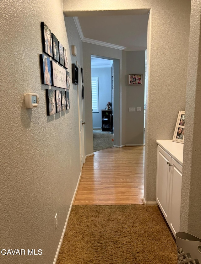 3309 W Brabham Ave, Rosamond, CA 93560 - hall with crown molding, a textured wall, light carpet, and light wood-type flooring