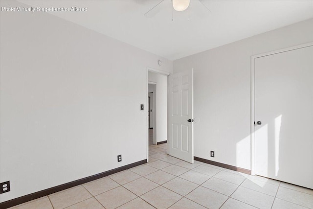 27192 Cote St, Boron, CA 93516 - empty room with ceiling fan, light tile patterned floors, and baseboards