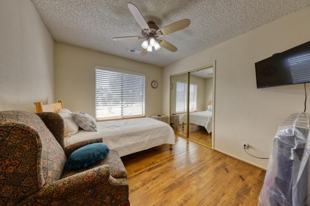 29948 Greenwater Dr, Tehachapi, CA 93561 - bedroom with wood-type flooring, a textured ceiling, ceiling fan, and a closet