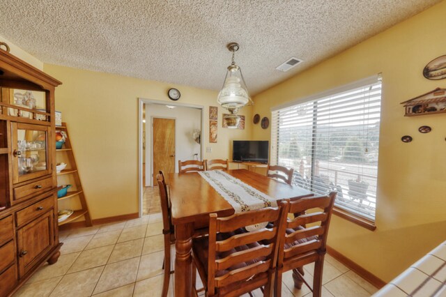29948 Greenwater Dr, Tehachapi, CA 93561 - dining room featuring a textured ceiling, light tile patterned floors, and baseboards