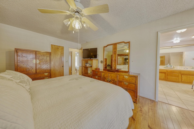 29948 Greenwater Dr, Tehachapi, CA 93561 - bedroom with light wood-style flooring, a textured ceiling, ensuite bathroom, and ceiling fan