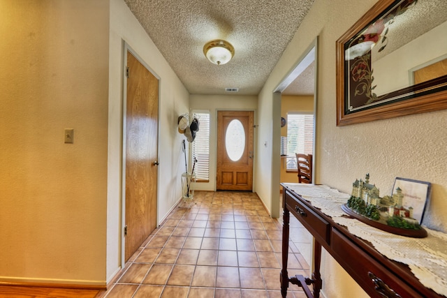 29948 Greenwater Dr, Tehachapi, CA 93561 - doorway to outside with a textured ceiling, a textured wall, and light tile patterned floors