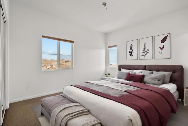 bedroom featuring multiple windows and baseboards