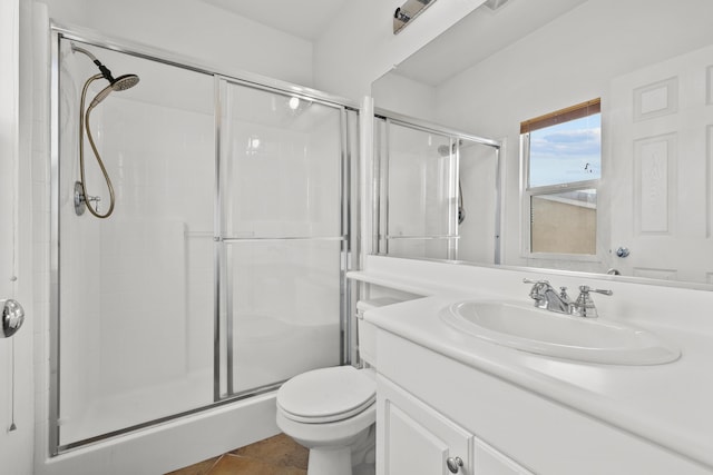 full bath with a stall shower, tile patterned flooring, vanity, and toilet