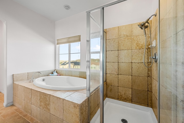 bathroom with a stall shower and a garden tub