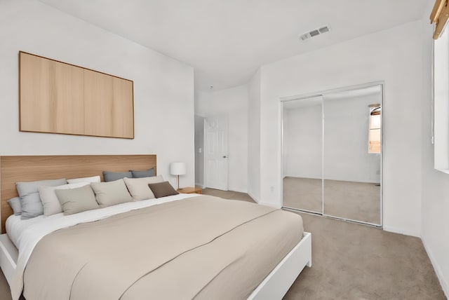 bedroom with light carpet, a closet, visible vents, and baseboards