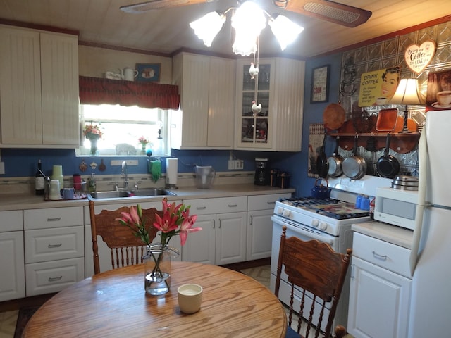 kitchen featuring white cabinets, ceiling fan, white appliances, and sink