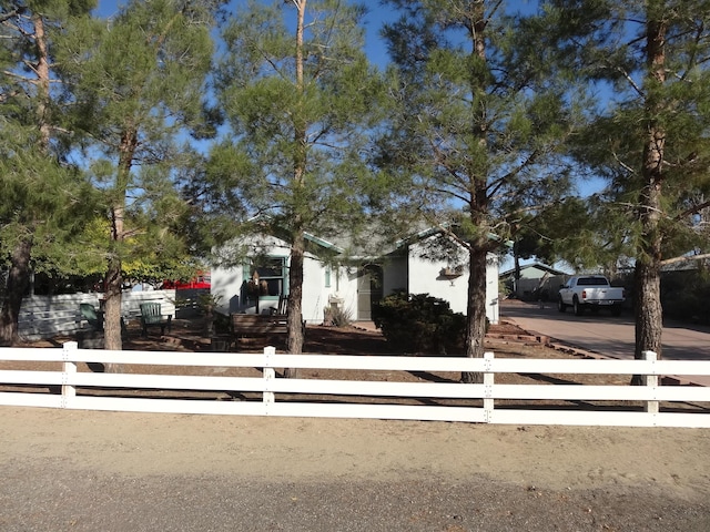 view of property hidden behind natural elements