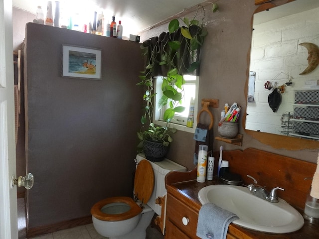 bathroom with tile patterned flooring, vanity, and toilet