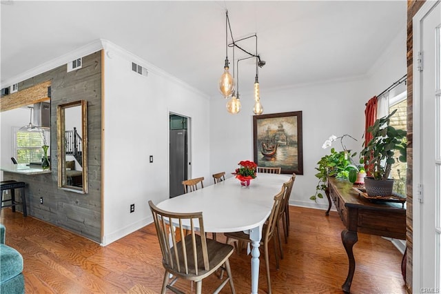 28314 Easton Ln, Saugus, CA 91350 - dining room featuring wood finished floors and ornamental molding