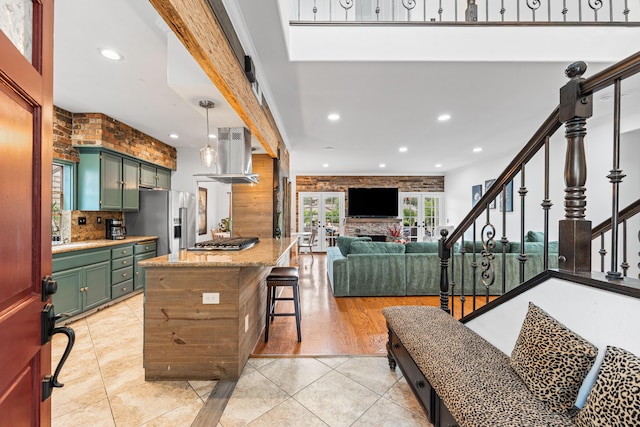 28314 Easton Ln, Saugus, CA 91350 - kitchen with green cabinetry, appliances with stainless steel finishes, island range hood, recessed lighting, and backsplash