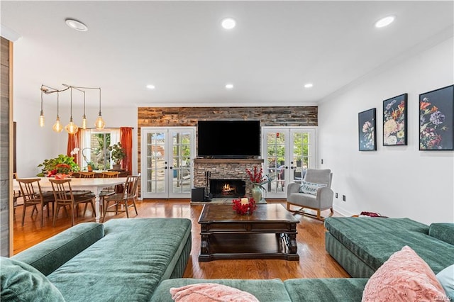 28314 Easton Ln, Saugus, CA 91350 - living area featuring french doors, ornamental molding, wood finished floors, a stone fireplace, and recessed lighting