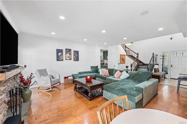 28314 Easton Ln, Saugus, CA 91350 - living area with stairs, light wood-style floors, crown molding, recessed lighting, and a fireplace with raised hearth