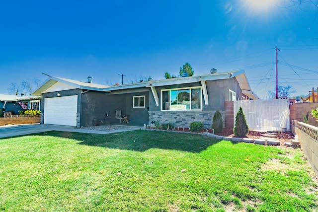 ranch-style home with a garage and a front lawn