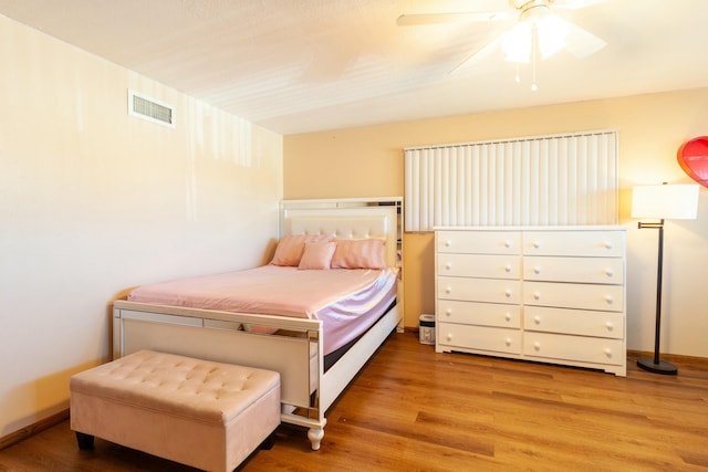 bedroom with ceiling fan and light hardwood / wood-style floors