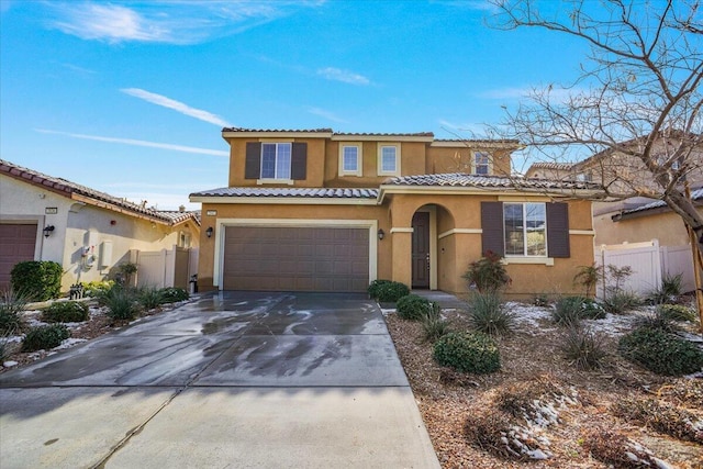 mediterranean / spanish-style home with a garage