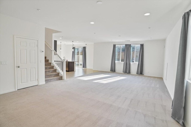 unfurnished living room with light colored carpet