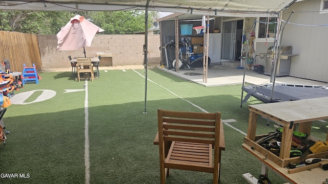 2325 E Pecos Ct, Lancaster, CA 93535 - fenced backyard with a patio area and a putting green