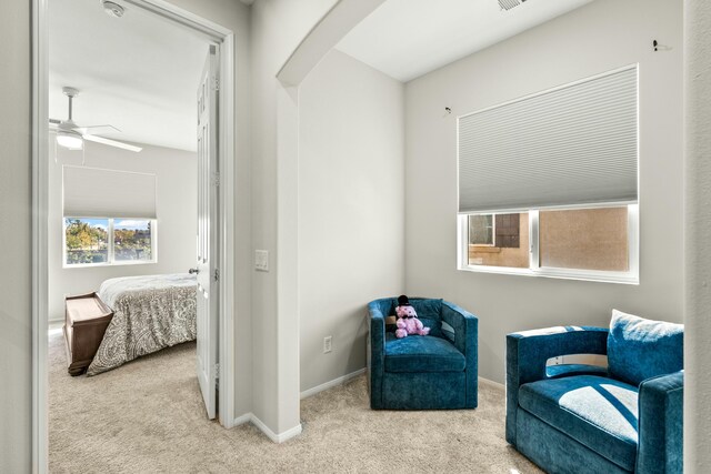 sitting room featuring ceiling fan and light colored carpet