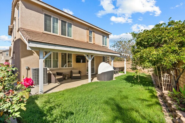 back of house with a patio area, a yard, and cooling unit