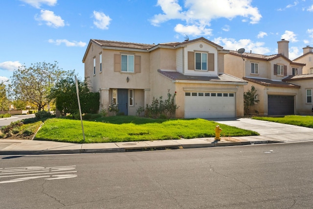 view of front of property with a front yard and a garage