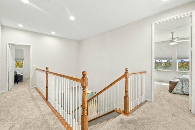 hallway featuring light carpet