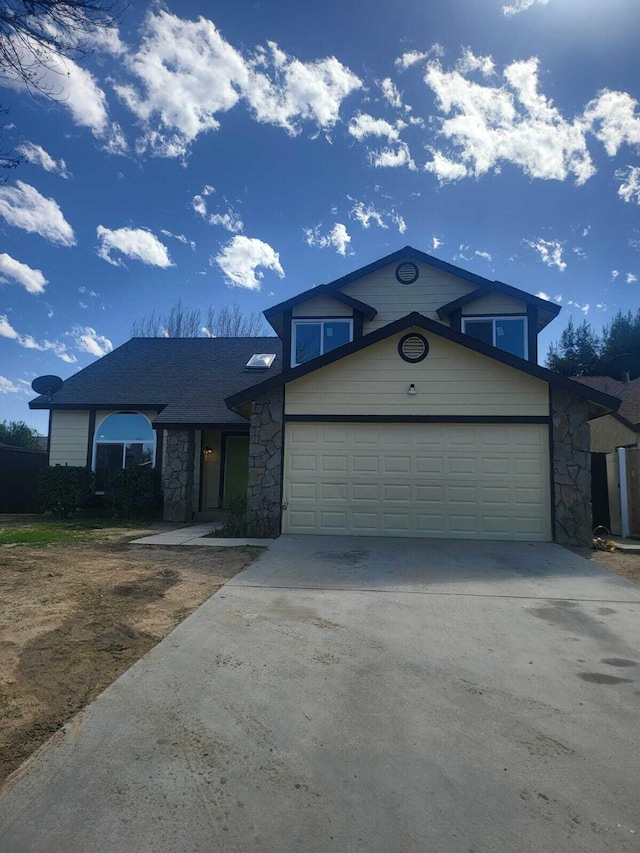 view of front of home featuring stone siding, driveway, and an attached garage