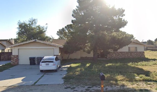 view of front of house featuring a garage and a front lawn