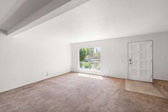 2823 W W Ave Unit J4, Lancaster, CA 93536 - unfurnished living room with carpet flooring, a textured ceiling, and baseboards
