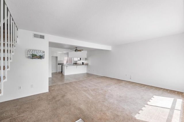 2823 W W Ave Unit J4, Lancaster, CA 93536 - unfurnished living room featuring light colored carpet, ceiling fan, and stairs