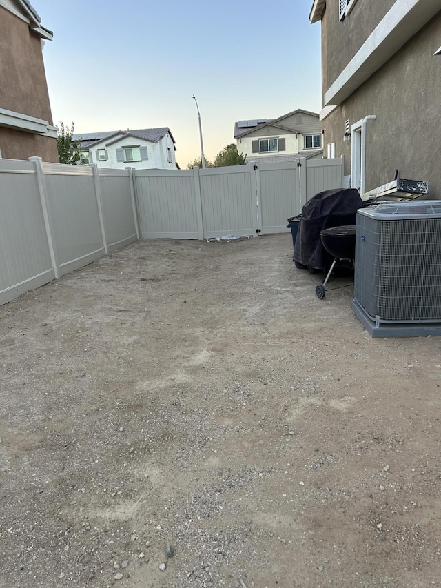 yard at dusk with cooling unit