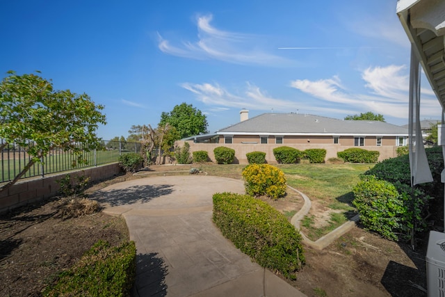 view of yard featuring fence and a patio area