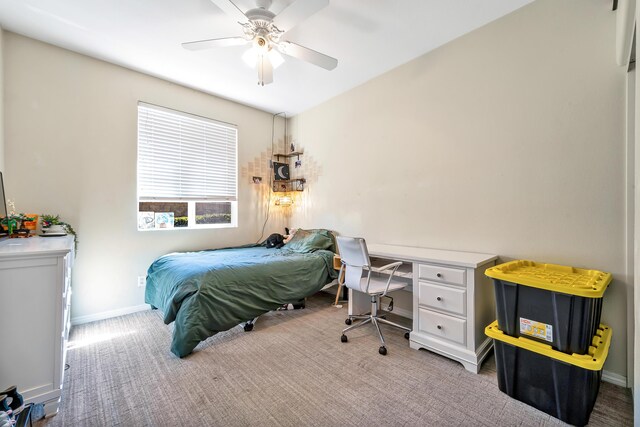 carpeted bedroom featuring baseboards and ceiling fan