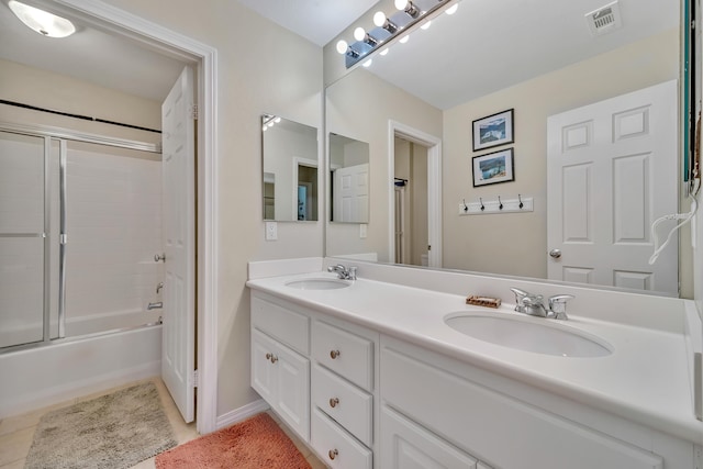 bathroom with tile patterned floors, double vanity, visible vents, and a sink