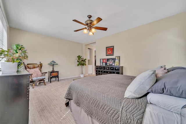 bedroom with carpet, baseboards, and a ceiling fan