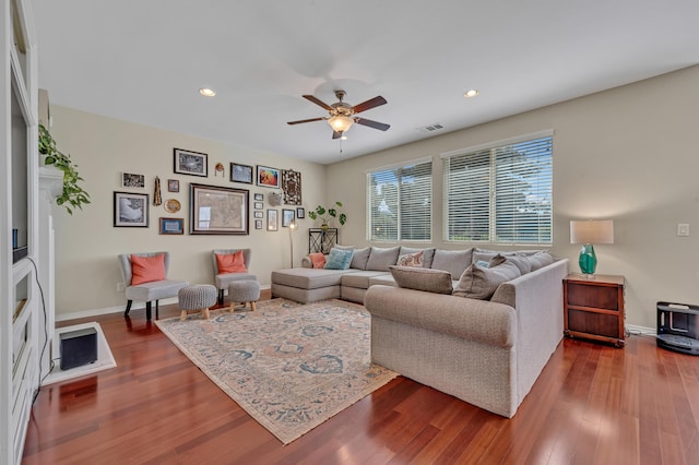 living room with visible vents, baseboards, dark wood-type flooring, ceiling fan, and recessed lighting
