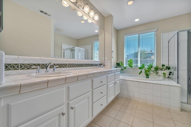 full bathroom featuring a stall shower, tile patterned floors, visible vents, and a sink