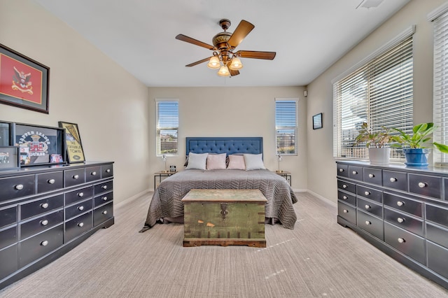 carpeted bedroom with baseboards and a ceiling fan